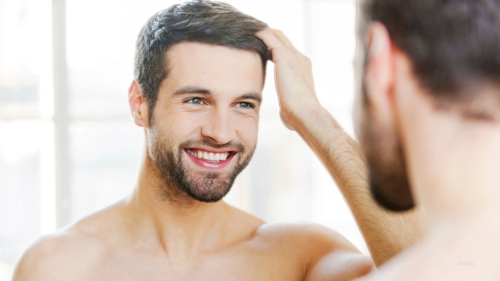 Man after hair growth solution treatment. (Model)